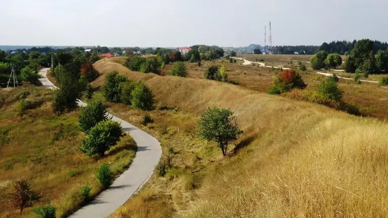 Modern view of Zmiyiv Ramparts showing impressive 15-meter height crossed by modern road